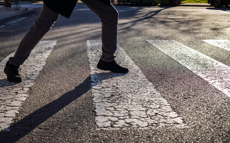 A person crossing the road at a crosswalk – a symbol of compulsive checking and rituals associated with obsessive-compulsive disorder (OCD).