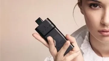 Woman holding a portable AirVape X vape