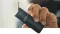 The hand is holding a black XMax Starry 3.0 vaporiser