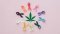 Cannabis leaf surrounded by ribbons symbolizing different types of cancer – connection of CBD and cancer therapy.