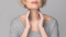 Woman palpating her neck – illustration of thyroid gland disorder symptoms.