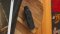 The Airvape Xs GO vaporizer in gray and black sits on a wooden table