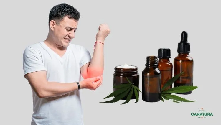 A man with elbow pain suffering from rheumatism, next to him bottles of CBD oil and cannabis ointment – CBD for relief from rheumatism and joint pain