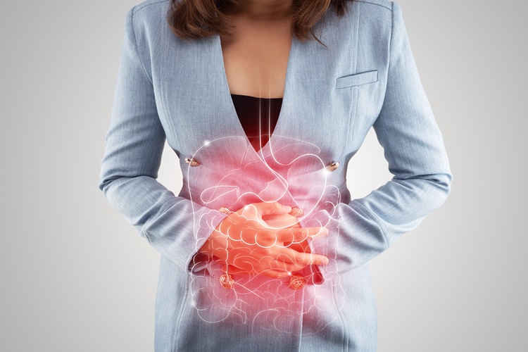 Woman in costume holding her stomach, displaying digestive tract