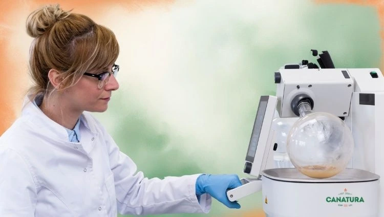 A woman in a laboratory operates a rotary evaporator, controlling the speed and vacuum for CBD oil extraction, with the Canatura logo in the bottom right corner