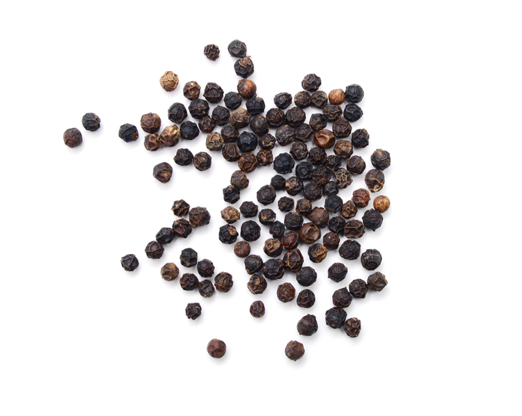 black peppercorns on a white background