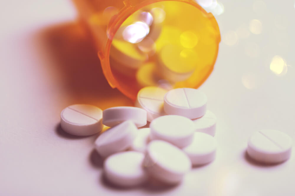 Medicines spilt from a jar - CBD can cause side effects that make the effects of the medicine stronger or weaker