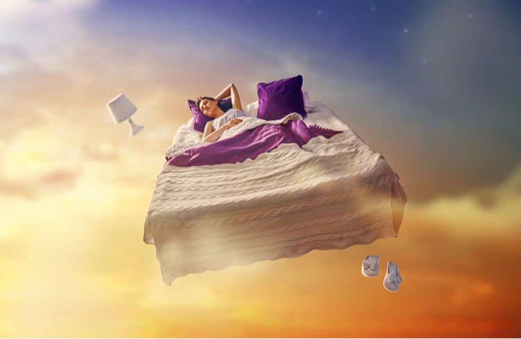 "Sleeping woman floating on a bed in a dreamlike sky — symbolizing deep sleep, vivid dreams, and the influence of cannabinoids on dreaming."
