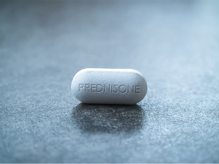 Image of Prednisone medication on a gray background