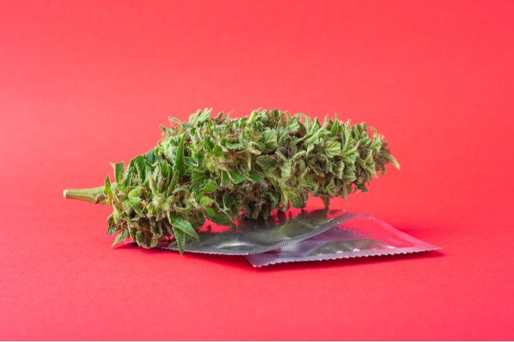 Cannabis bud and condom as a symbol of CBD and sexual health